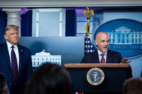 President Donald Trump looks on as FDA Commissioner Stephen Hahn addresses the media during a press conference at the White House in Washington, DC, on August 23.