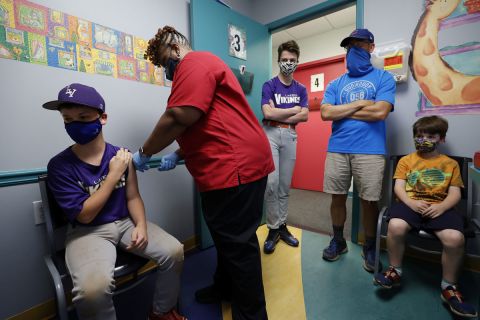 Family members look on as Jack Frilingos, 12, is inoculated with Pfizer's vaccine against Covid-19 after Georgia authorized the vaccine for ages 12 and up, at Dekalb Pediatric Center in Decatur, Georgia on on May 11.