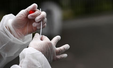 A medical staff member holds a nasal swab as he collects samples from a person at a Covid-19 test site in Brest, France, in July 2020.