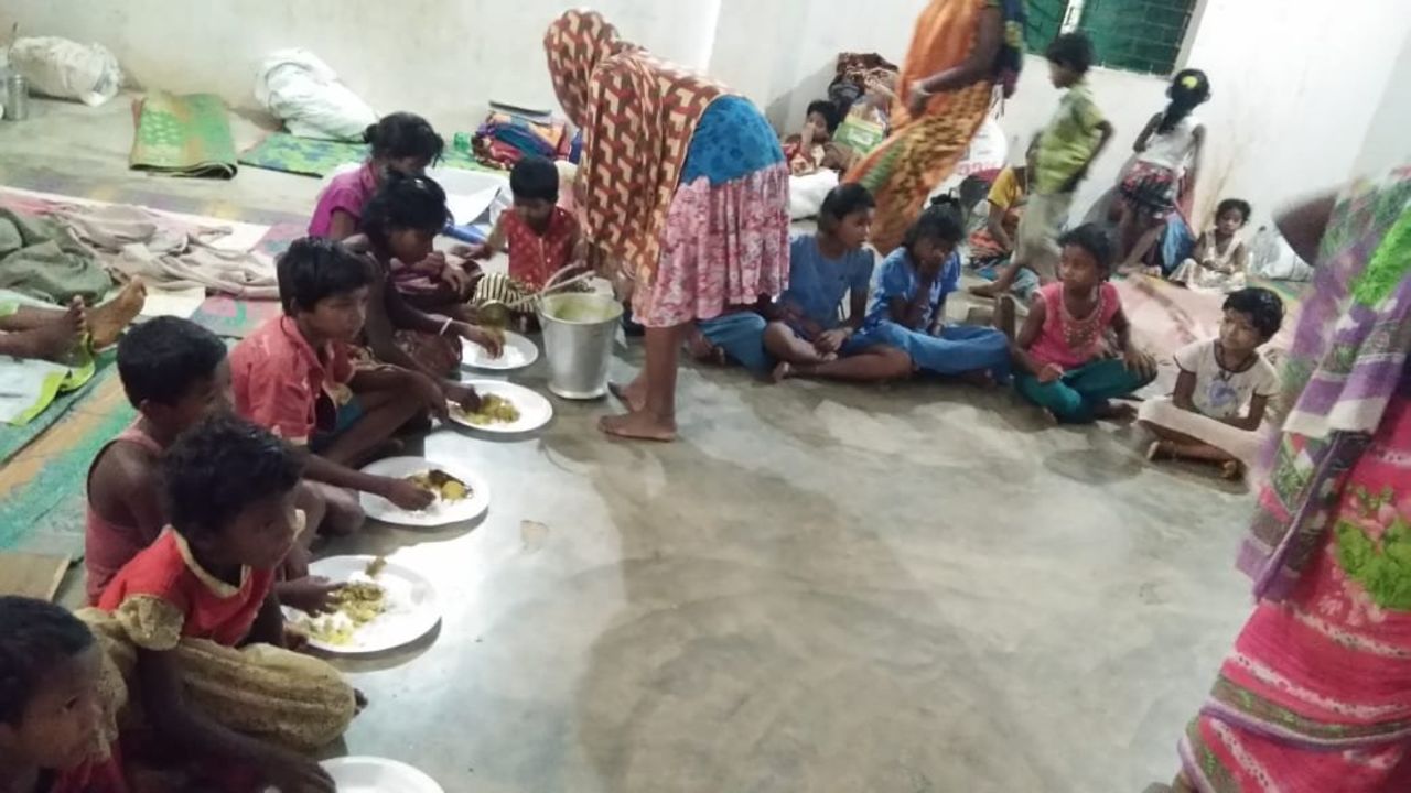 Children are fed at one of the emergency shelters in Puri. 