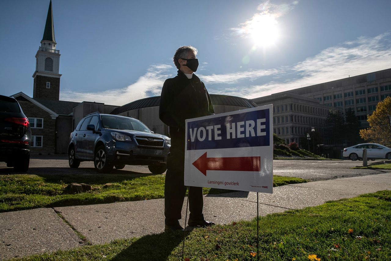 Poll observer Sue Carter stands near a polling place while watching for potential voter intimidation on Tuesday in Lansing, Michigan. 