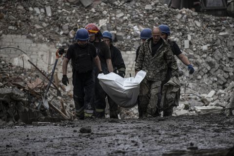 Firefighters remove a body from a building amid search and rescue operations in Chasiv Yar, Donetsk, Ukraine, on July 11.