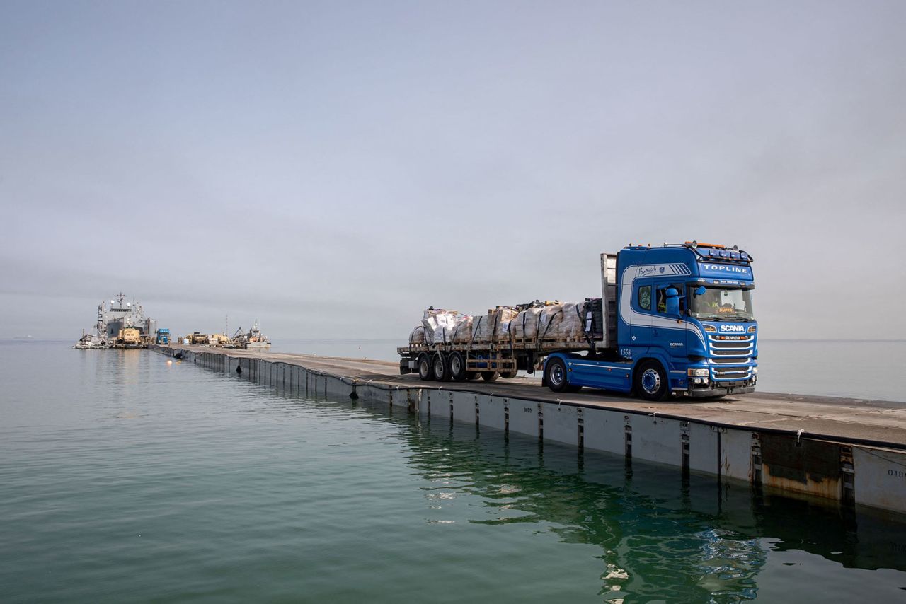 A truck carries humanitarian aid across Trident?Pier, a temporary?pier?to deliver aid, off of?Gaza on May 19.