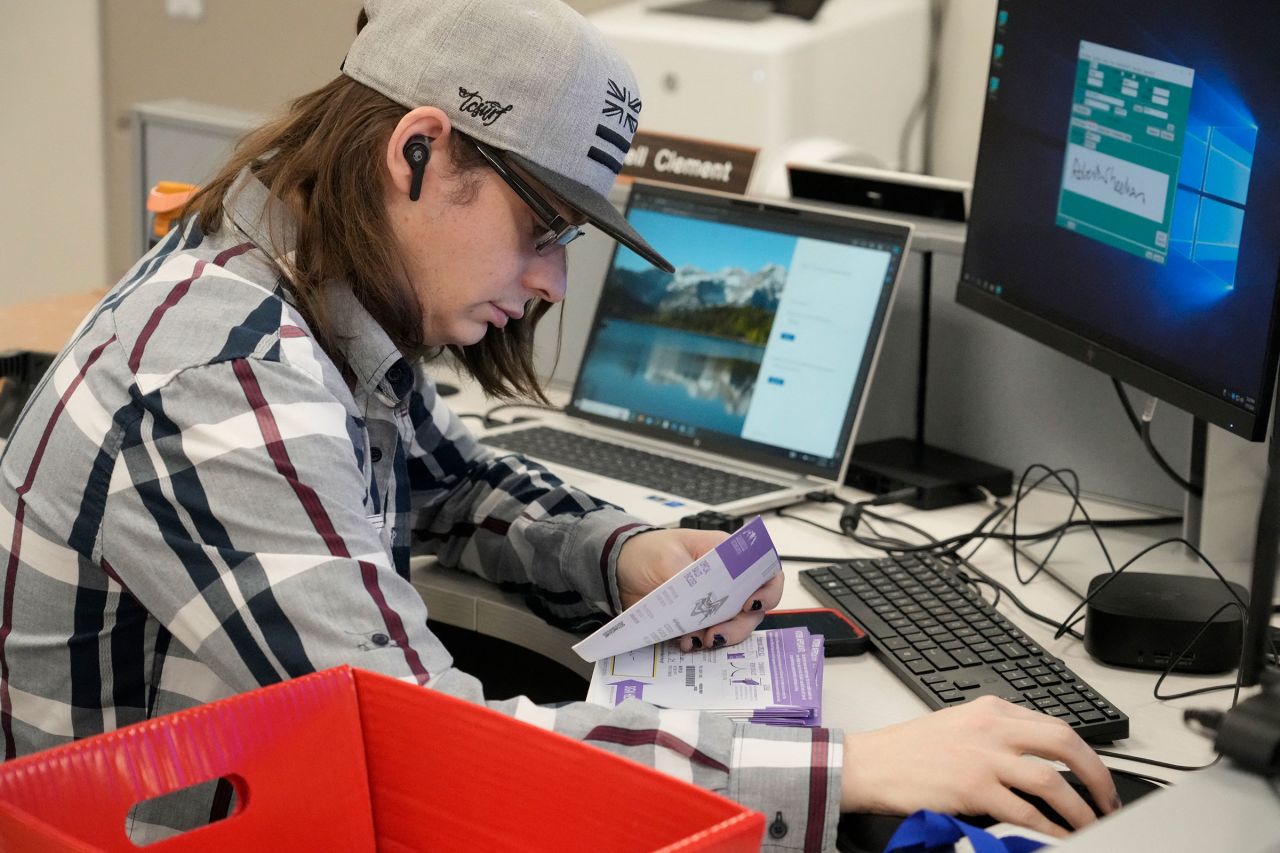 An election worker starts the process of curing a defective ballot at Utah County Election Headquarters during the presidential primary in Provo, Utah, on Tuesday.