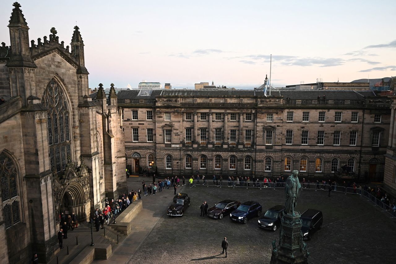 People wait outside of St. Giles' Cathedral to pay their respects to Queen Elizabeth II Monday evening.