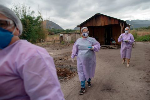 Health professionals leave a home after administering COVID-19 tests to an elderly indigenous Guarani couple at the Sao Mata Verde Bonita tribe camp, in Marica, Rio de Janeiro state, Brazil, on July 2.