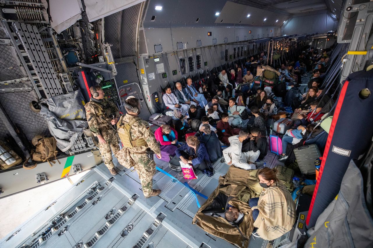 Evacuees from Kabul sit inside a military aircraft in Tashkent, Uzbekistan, on August 17, before reaching their final destination in Germany.?