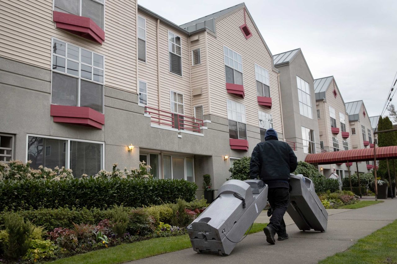 Hand washing stations are delivered to the Ida Culver House Ravenna retirement community in north Seattle, Washington, on Tuesday. A resident of the center who had been hospitalized and then tested positive for coronavirus reportedly died Monday.