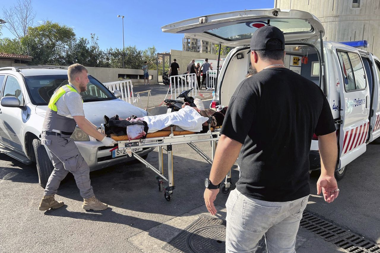 Civil Defense first-responders carry a wounded man whose handheld pager exploded, at al-Zahraa hospital in Beirut, Lebanon, on September 17.