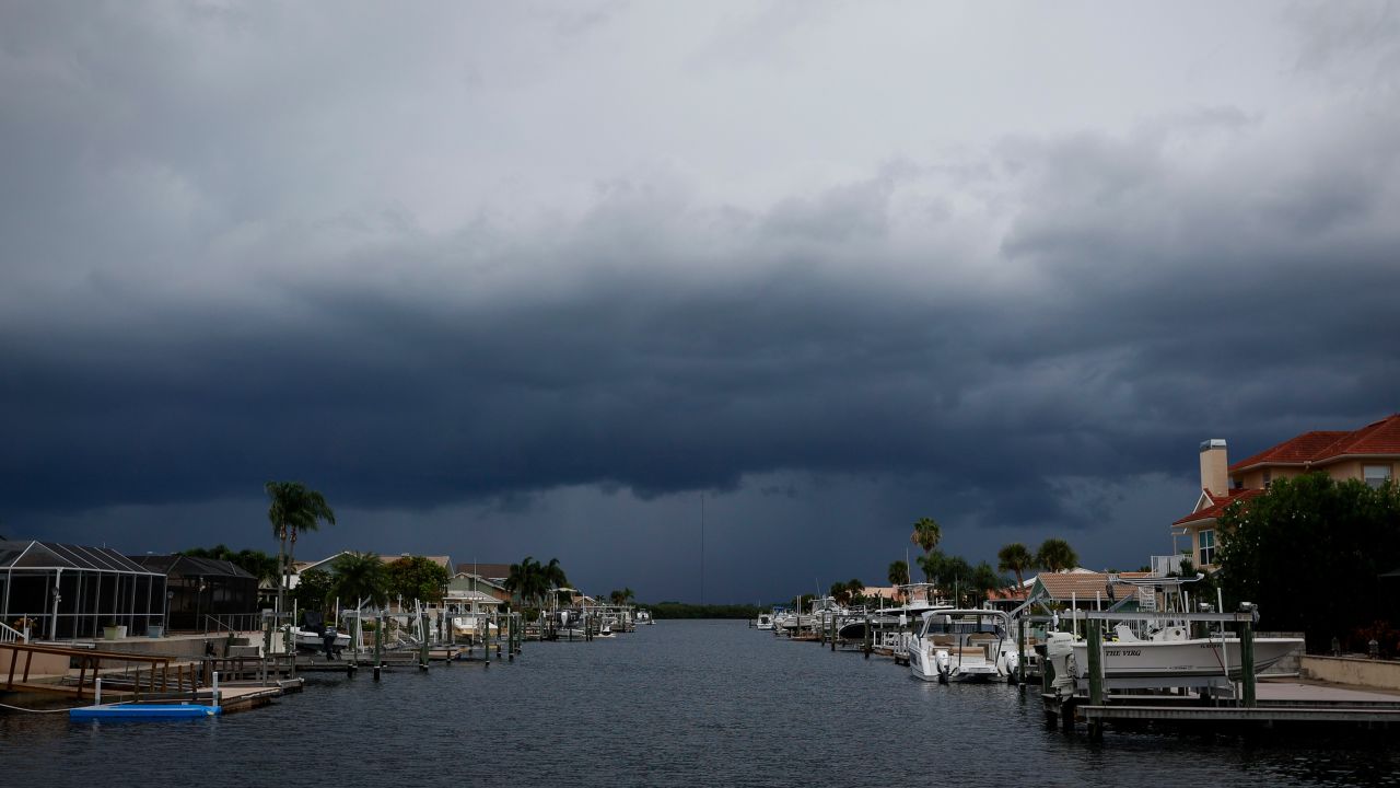 Storm clouds are seen building in the distance over a canal in Port Richey, Florida, on August 29.