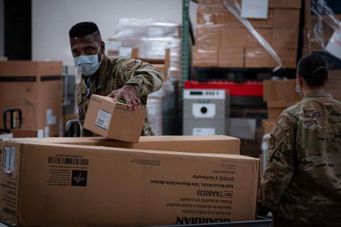 Task Force McGuire-Dix Airmen prepare personal protective equipment to aid in the arrival of Afghans in support of the Department of State-led Operation Allies Refuge on Joint Base McGuire-Dix-Lakehurst, New Jersey, Aug. 21.