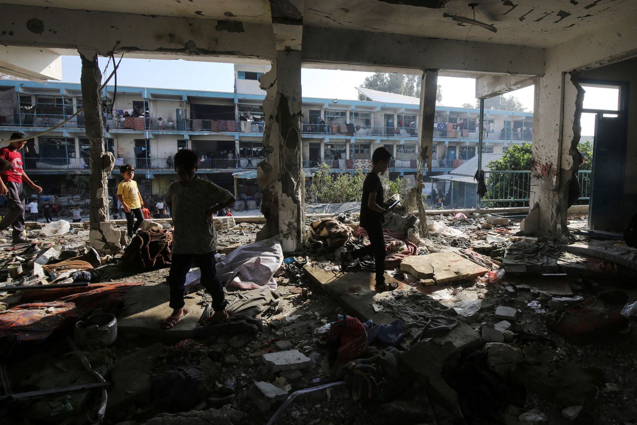 Palestinians inspect damage after an Israeli airstrike on a United Nations-run school in Deir El-Balah, Gaza, on June 6.