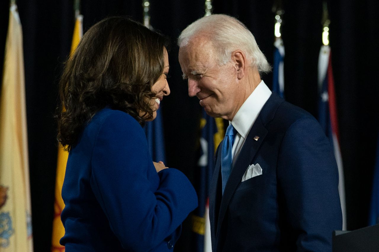 In this Aug. 12, file photo, Democratic presidential candidate former Vice President Joe Biden and his running mate Sen. Kamala Harris, D-Calif., pass each other in Wilmington, Del. 