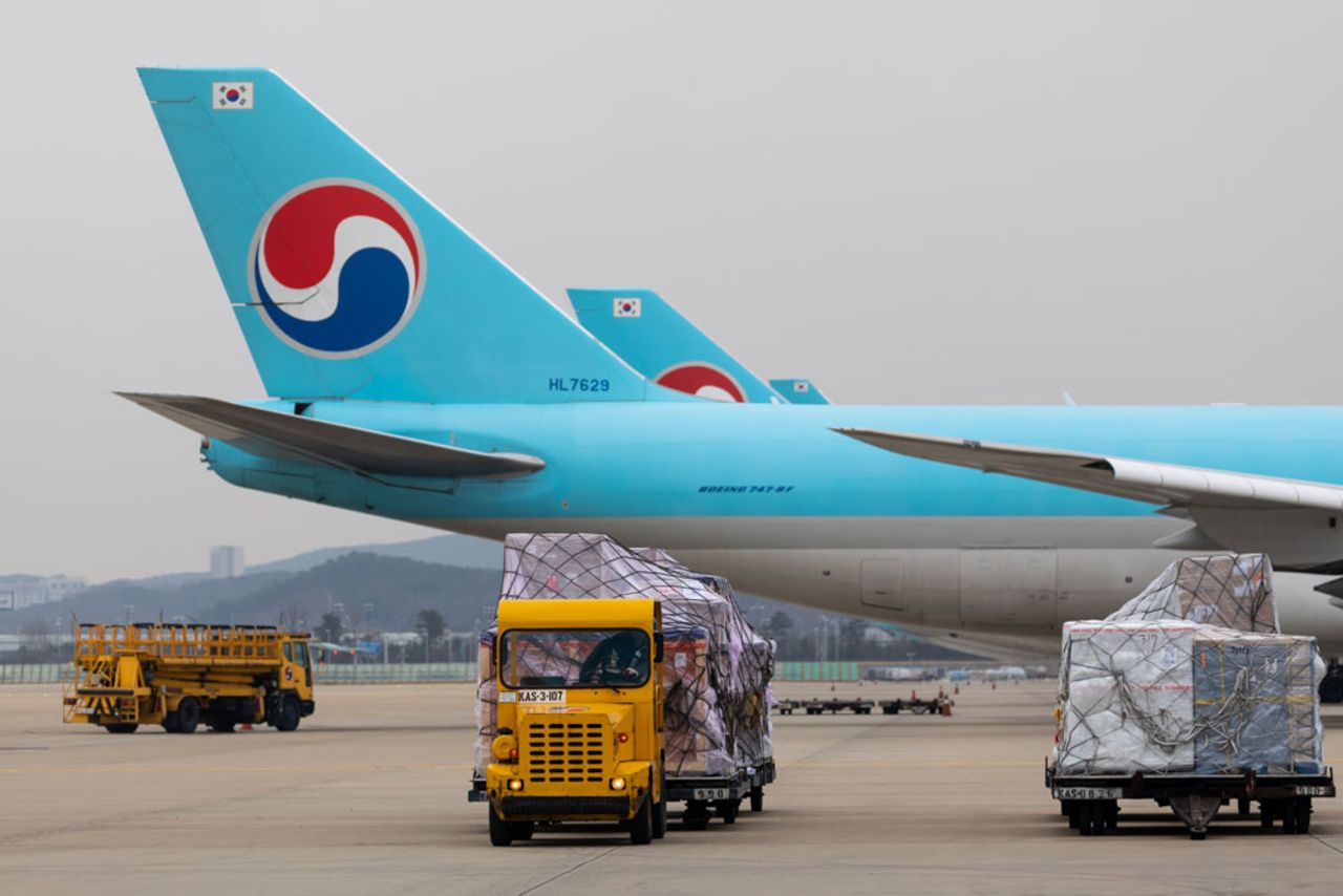 A Korea Airport Service staff member drives a trailer truck to move cargo at the Korean Air cargo terminal at Incheon International Airport in Incheon, South Korea, on Wednesday, January 1.