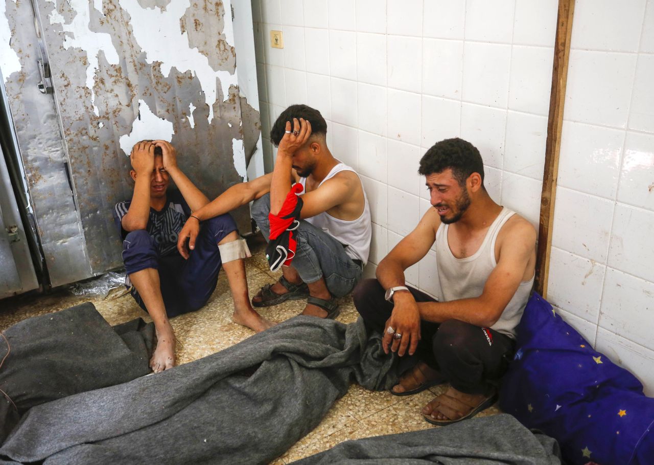 People mourn over the bodies of Palestinians killed in an Israeli attack in Deir al-Balah, Gaza, on June 8.