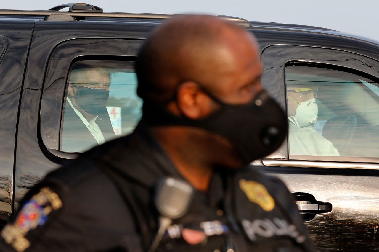 President Donald Trump sits inside a car on October 4 while it drives outside Walter Reed medical center in Bethesda, Maryland.