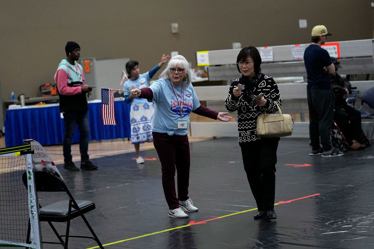 Poll workers direct voters at a polling place on November 8, in Las Vegas.