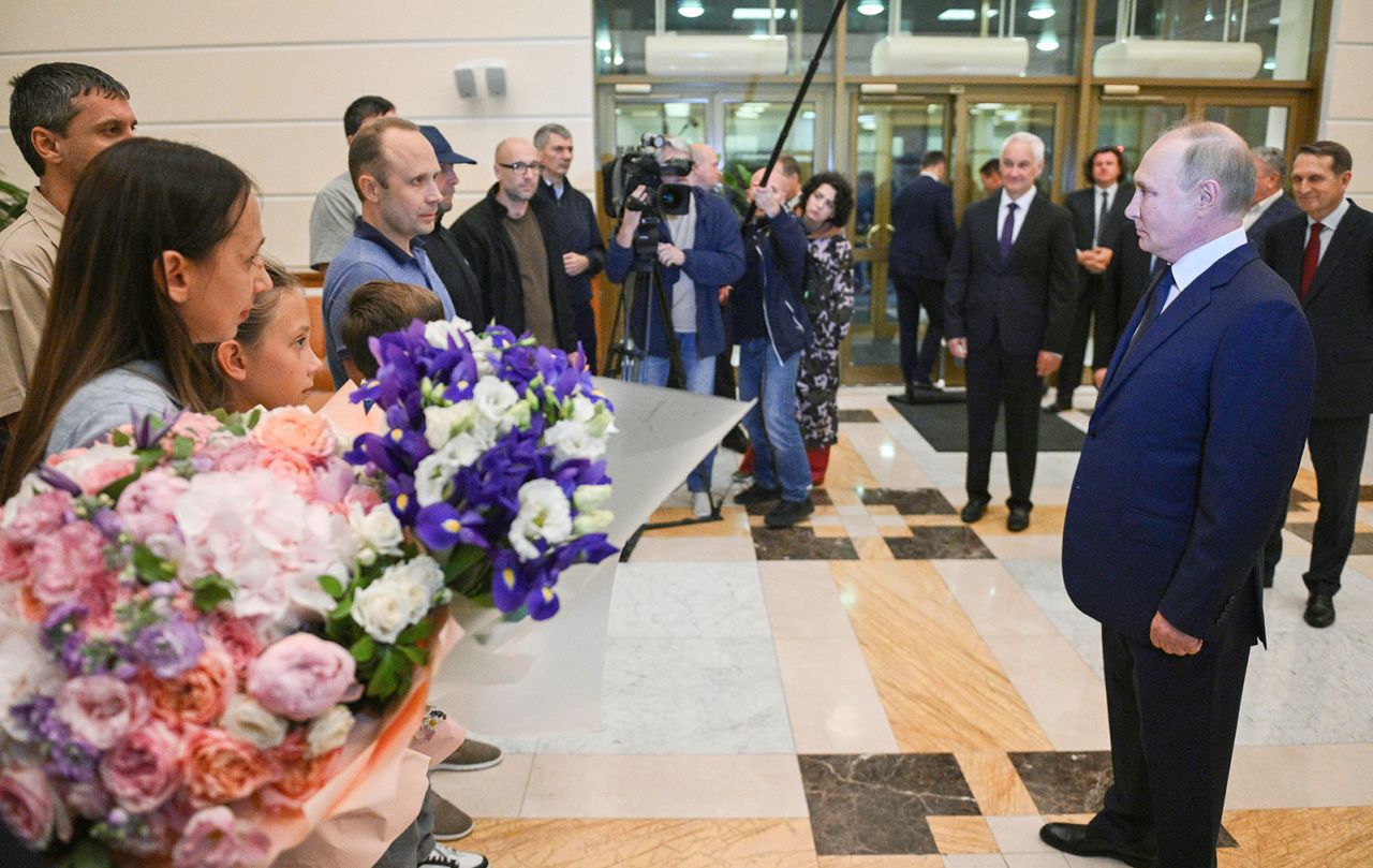 Russian President Vladimir Putin, right, greets released Russian prisoners and relatives at the Vnukovo government airport outside Moscow, Russia, on Thursday, August 1. 