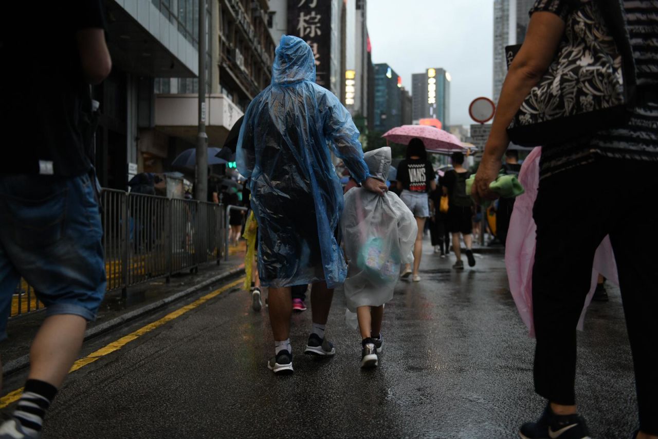 A family marches on in the rain. 