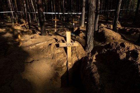 Unidentified makeshift graves are seen at the Pishanske cemetery in Izium, on Friday.