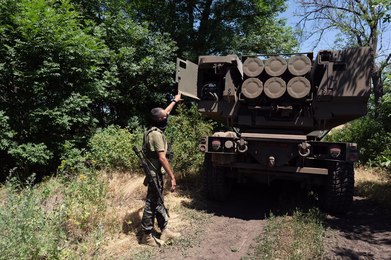 The commander of the unit checks the rockets on a HIMARS vehicle in Eastern Ukraine on July 1.