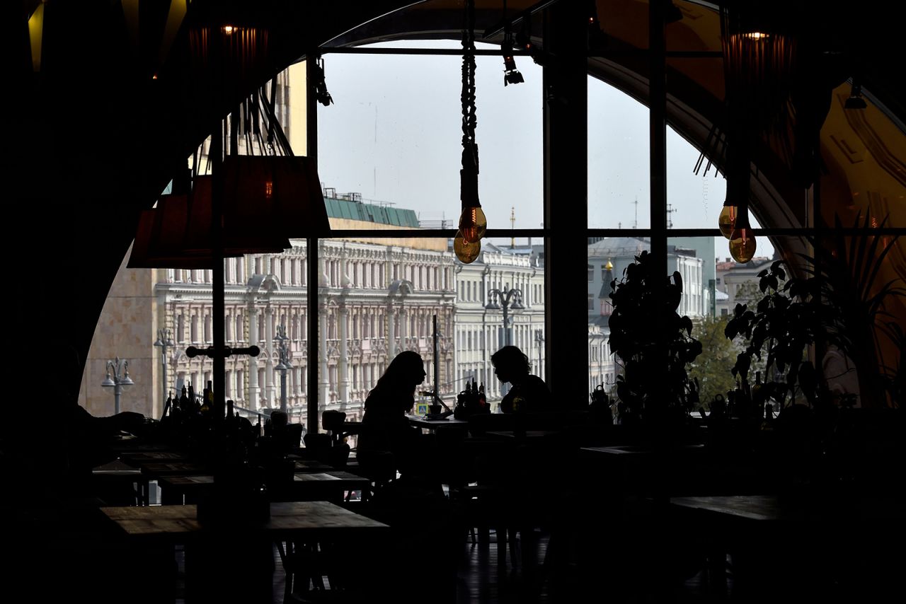 Women eat lunch in an almost empty restaurant in Moscow on September 29.