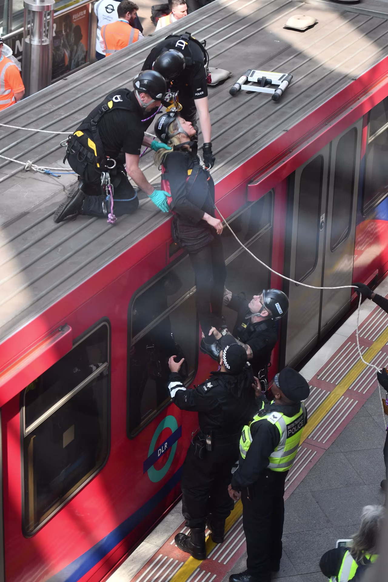 The second climate change activist is lowered from the train roof. 