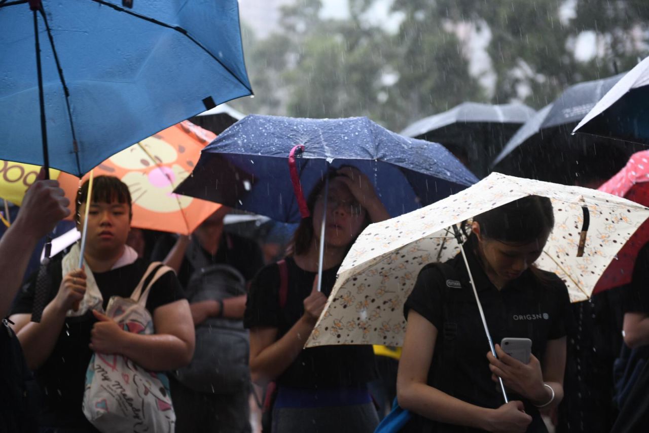 Protesters huddle under umbrellas in Victoria Park in Hong Kong. 