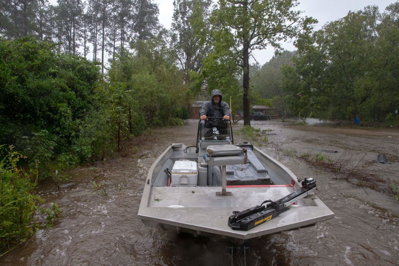 Rescuer John Bridges with the Cajun Navy rides a boat on a trailer after completing a rescue in Lumberton, North Carolina, in 2018 in the wake of Hurricane Florence.