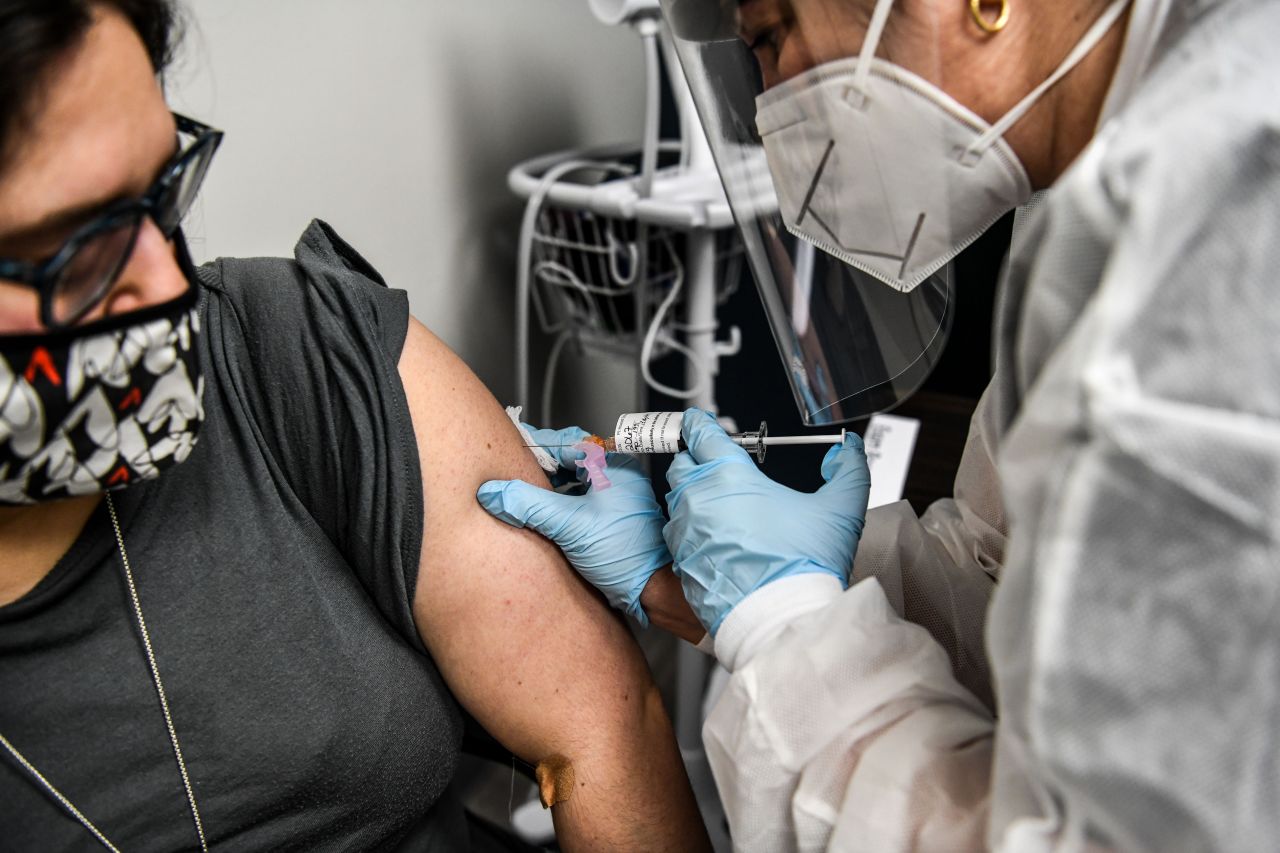 Heather Lieberman, 28, receives a Covid-19 vaccination from Yaquelin De La Cruz at the Research Centers of America in Hollywood, Florida, on August 13.