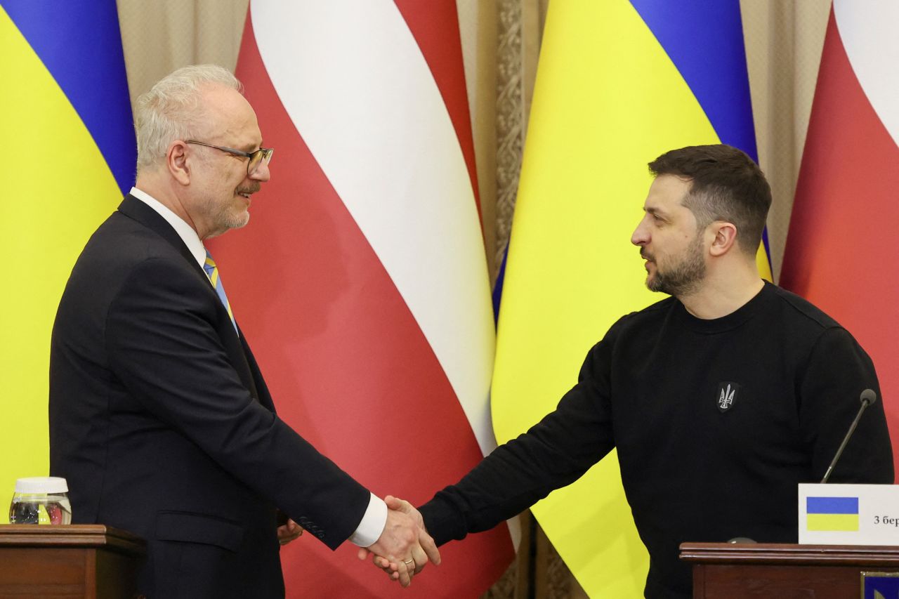 Ukrainian President Volodymyr Zelensky and?Latvian?President?Egils Levits shake hands during a joint news briefing, in Lviv, Ukraine on Friday.