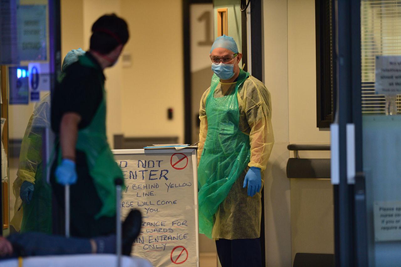 NHS staff in personal protective equipment recieve a patient at Aintree University Hospital in Liverpool, England on Thursday, April 16. 