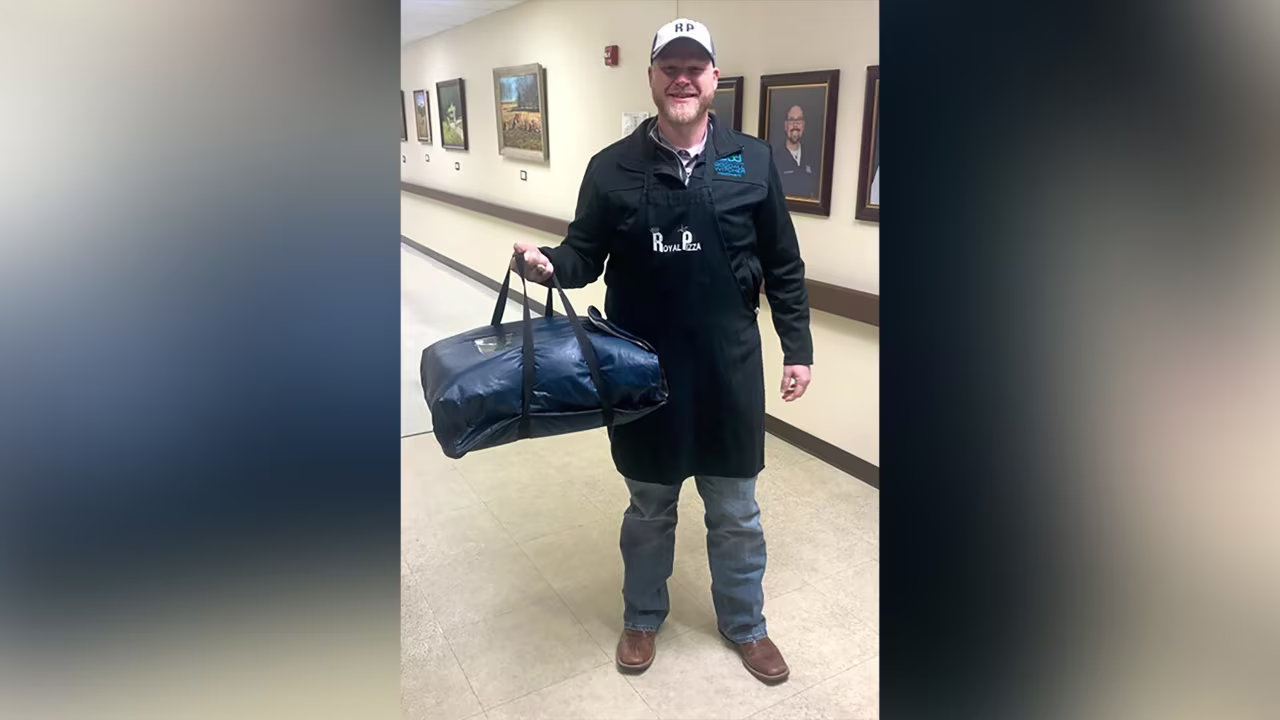 Adam Willmann, president and CEO of Goodall-Witcher Healthcare, delivers pizza to employees.