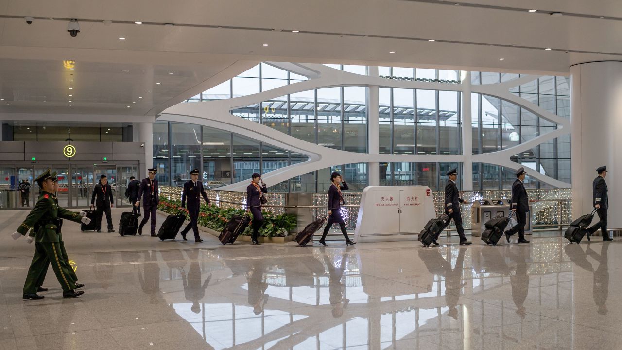An airline crew enters the Beijing Daxing International Airport on January 21. 