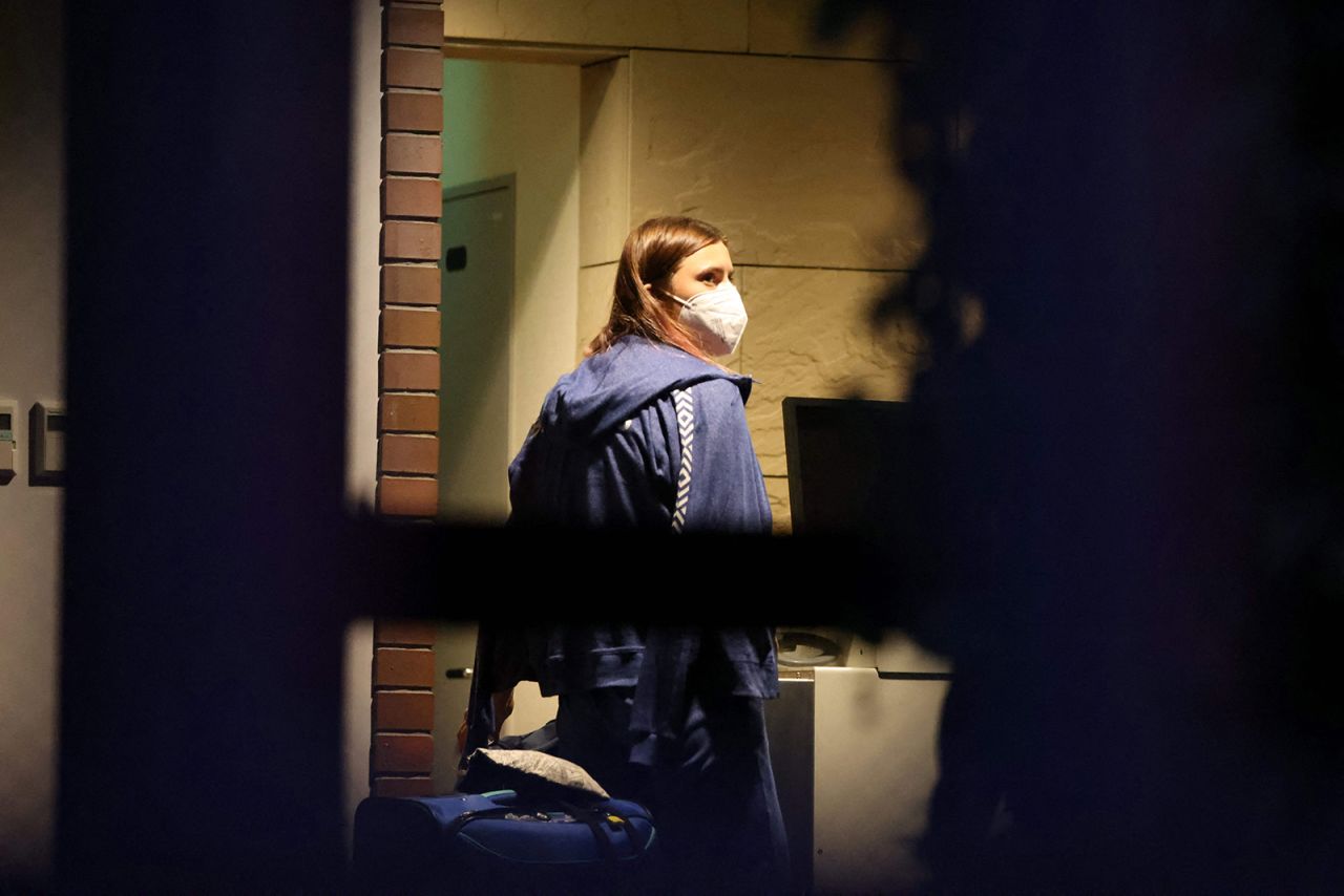 Belarus athlete Kristina Timanovskaya walks with her luggage inside the Polish embassy in Tokyo on August 2. 