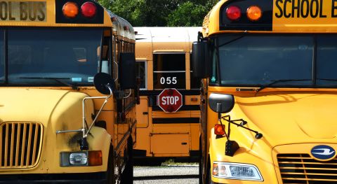 School buses are seen parked at a school in Winter Springs, Florida, in August 2020.