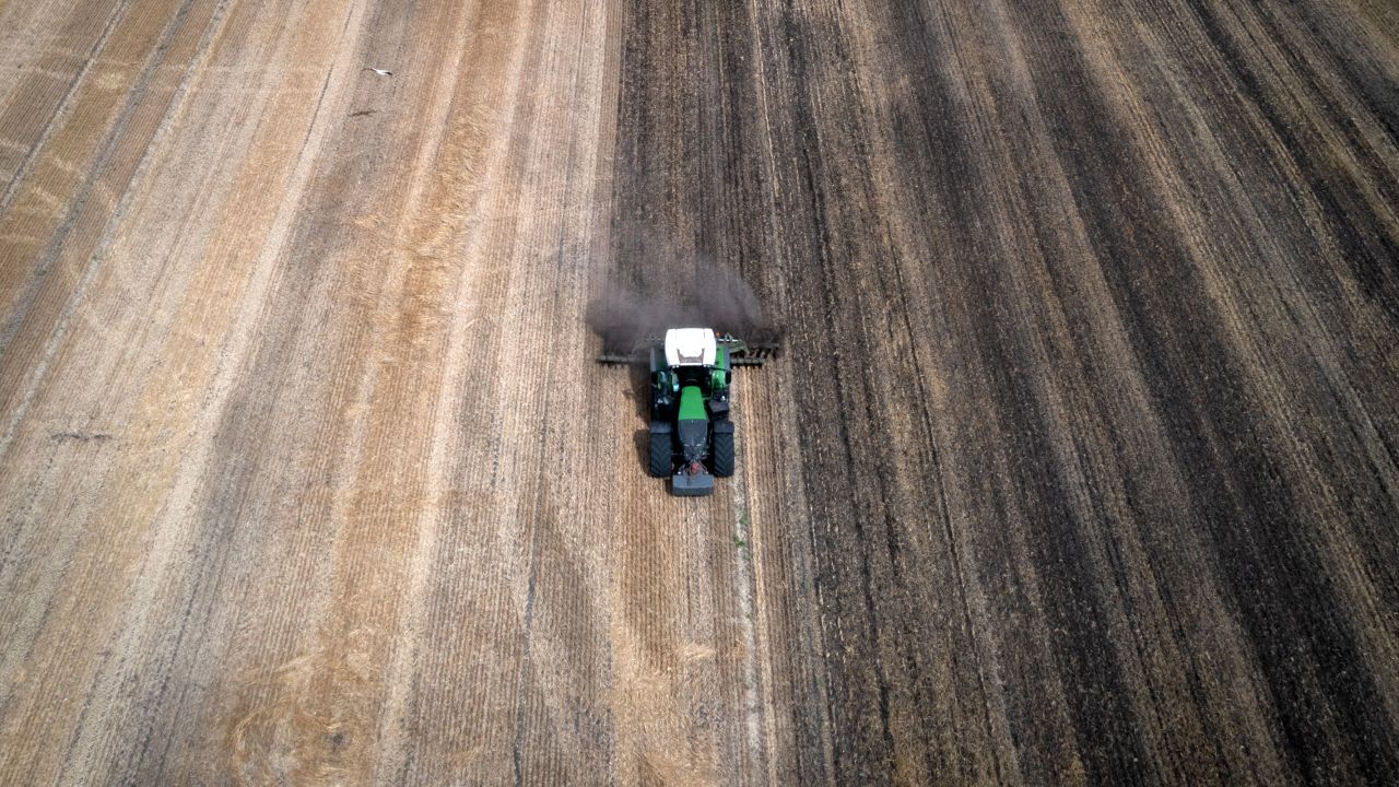 A tractor works the field on a private farm in Zhurivka, Kyiv region, Ukraine, Thursday, Aug. 10, 2023. 