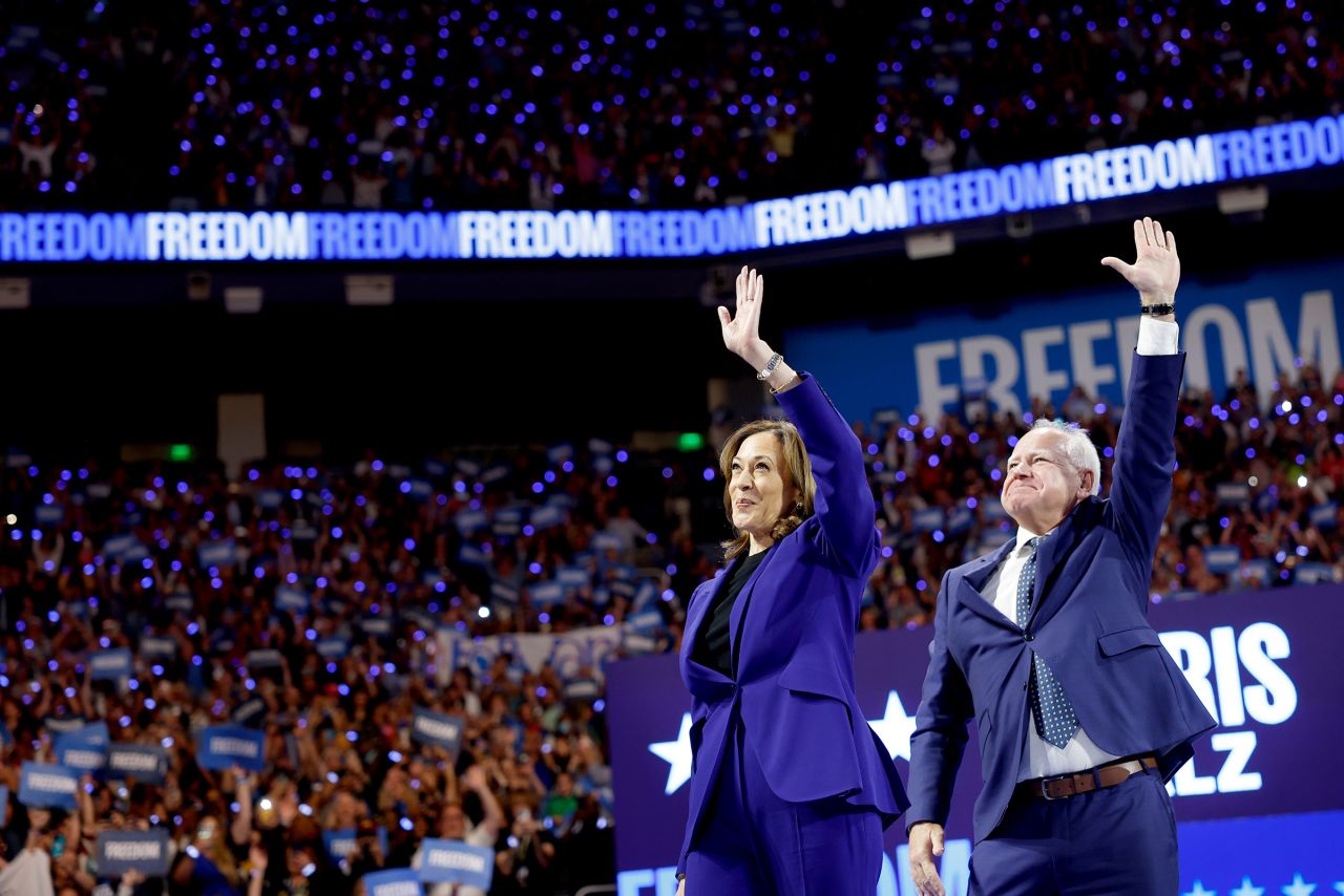 Democratic presidential candidate, Vice President Kamala Harris and democratic vice presidential candidate Minnesota Gov. Tim Walz walk onstage for a campaign rally at the Fiserv Forum  in Milwaukee, Wisconsin on August 20.