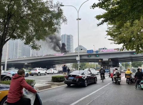 Protest banners hang on the Sitong Bridge in Beijing on October 13.