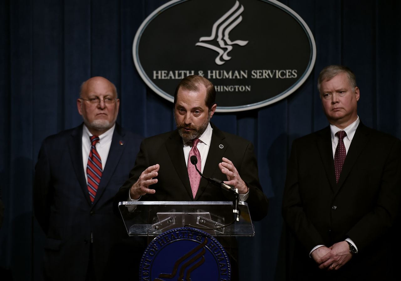 US Health and Human Services Secretary Alex Azar speaks as Centers for Disease Control and Prevention (CDC) Director Robert R. Redfield (left) and Deputy Secretary of State Stephen Biegun (right) listen during a news conference on Friday in Washington.