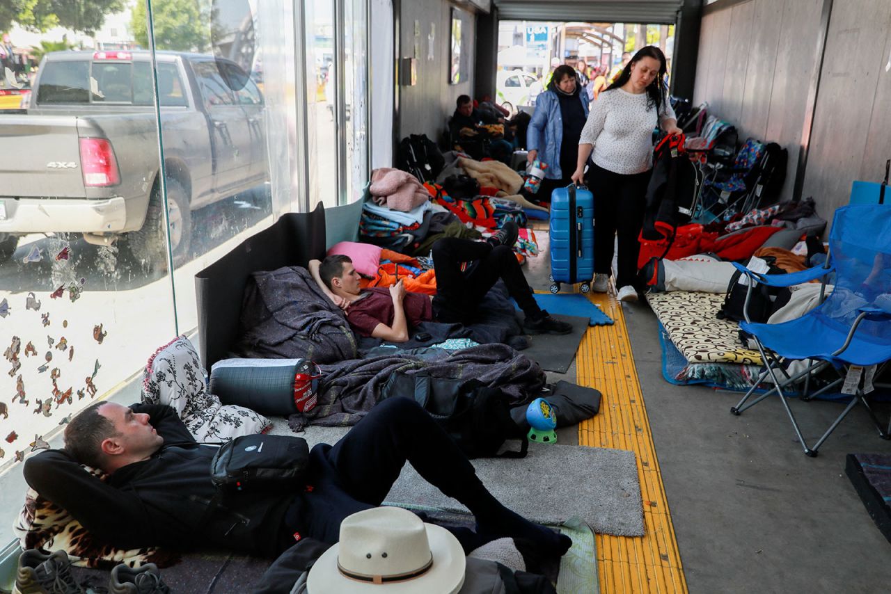 Ukrainian refugees wait to enter the United States at the San Ysidro Port of Entry at the US-Mexico border, in Tijuana, Mexico, on Monday.
