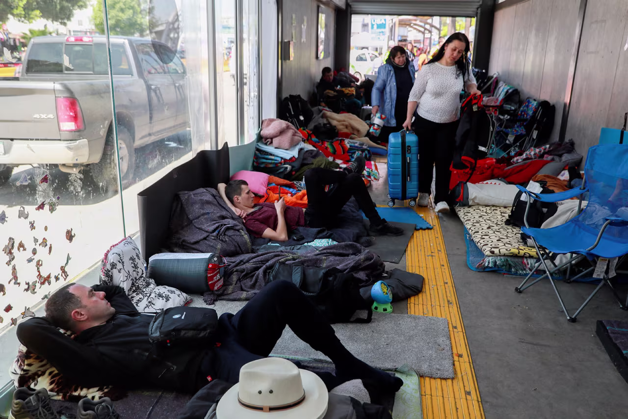 Ukrainian refugees wait to enter the United States at the San Ysidro Port of Entry at the US-Mexico border, in Tijuana, Mexico, on Monday.