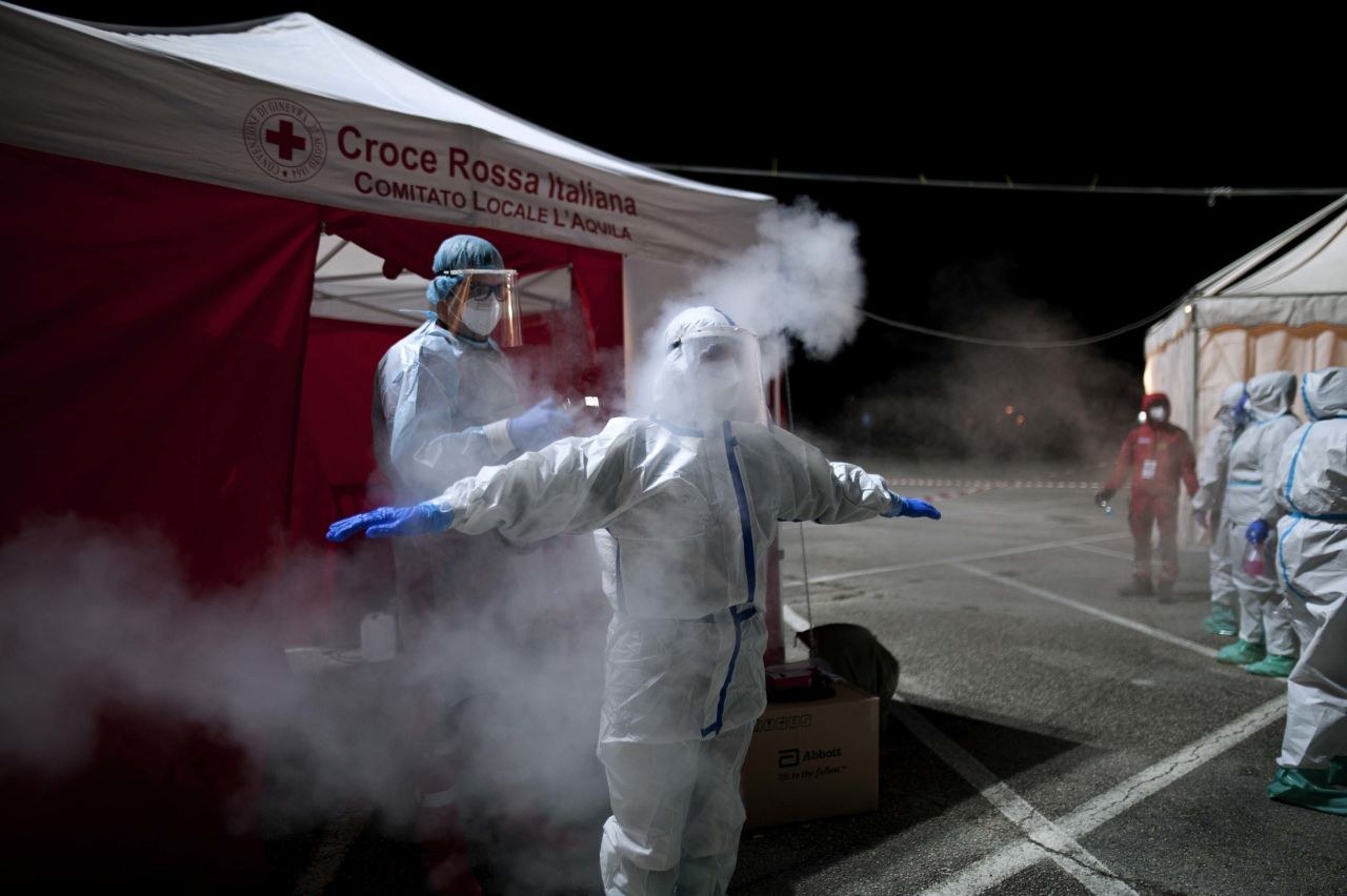 A health worker is sanitized at a Covid-19 testing site in the Italian city of L'Aquila, Abruzzo, on December 6.