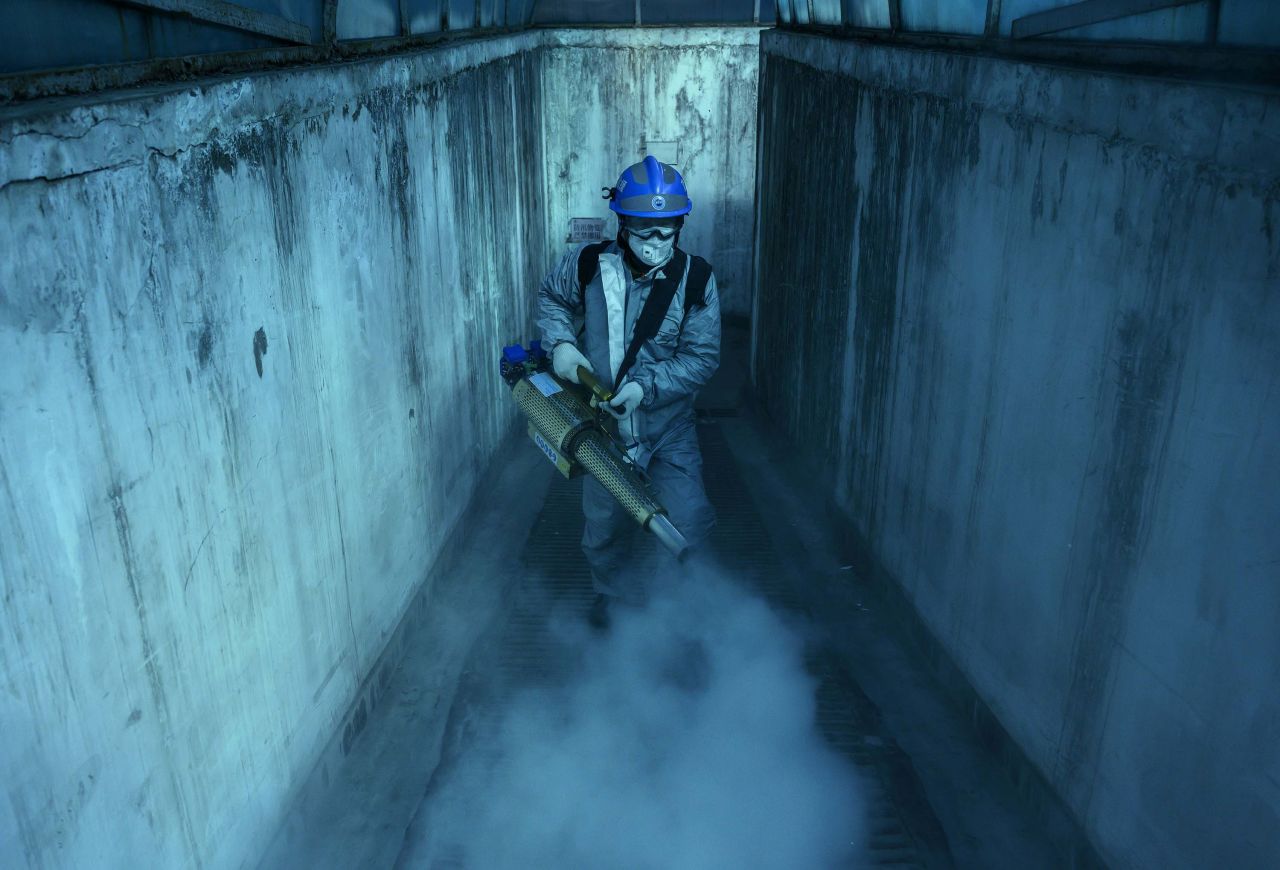 A volunteer from Blue Sky Rescue uses fumigation equipment to disinfect common areas of a local residential compound in Beijing, China on March 5.