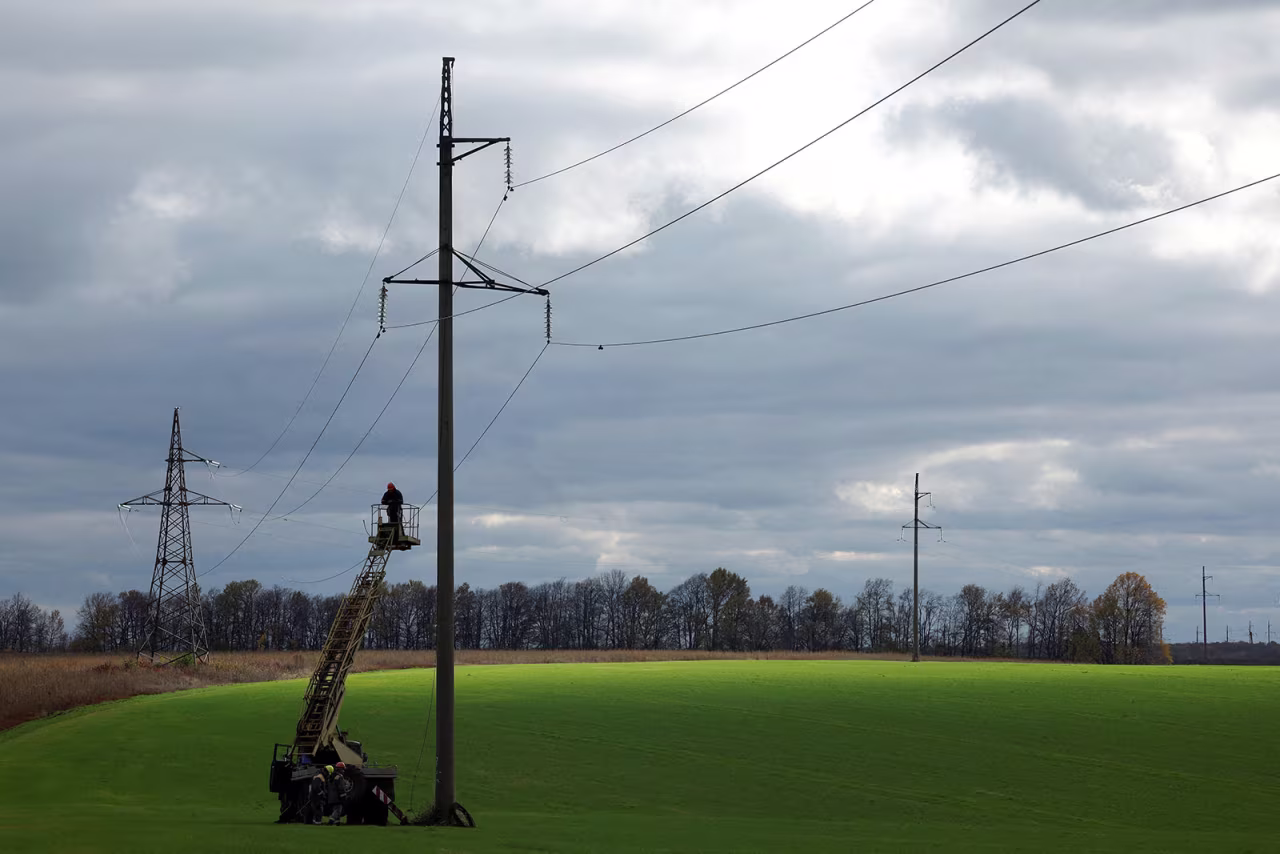 Electricians repair a power line damaged from shelling in Kharkiv, Ukraine, on October 21. 