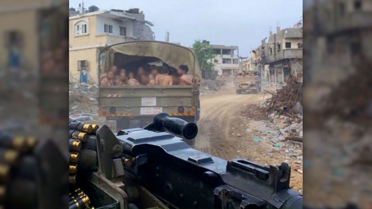 The men can be seen in the cargo bed of a military vehicle. 