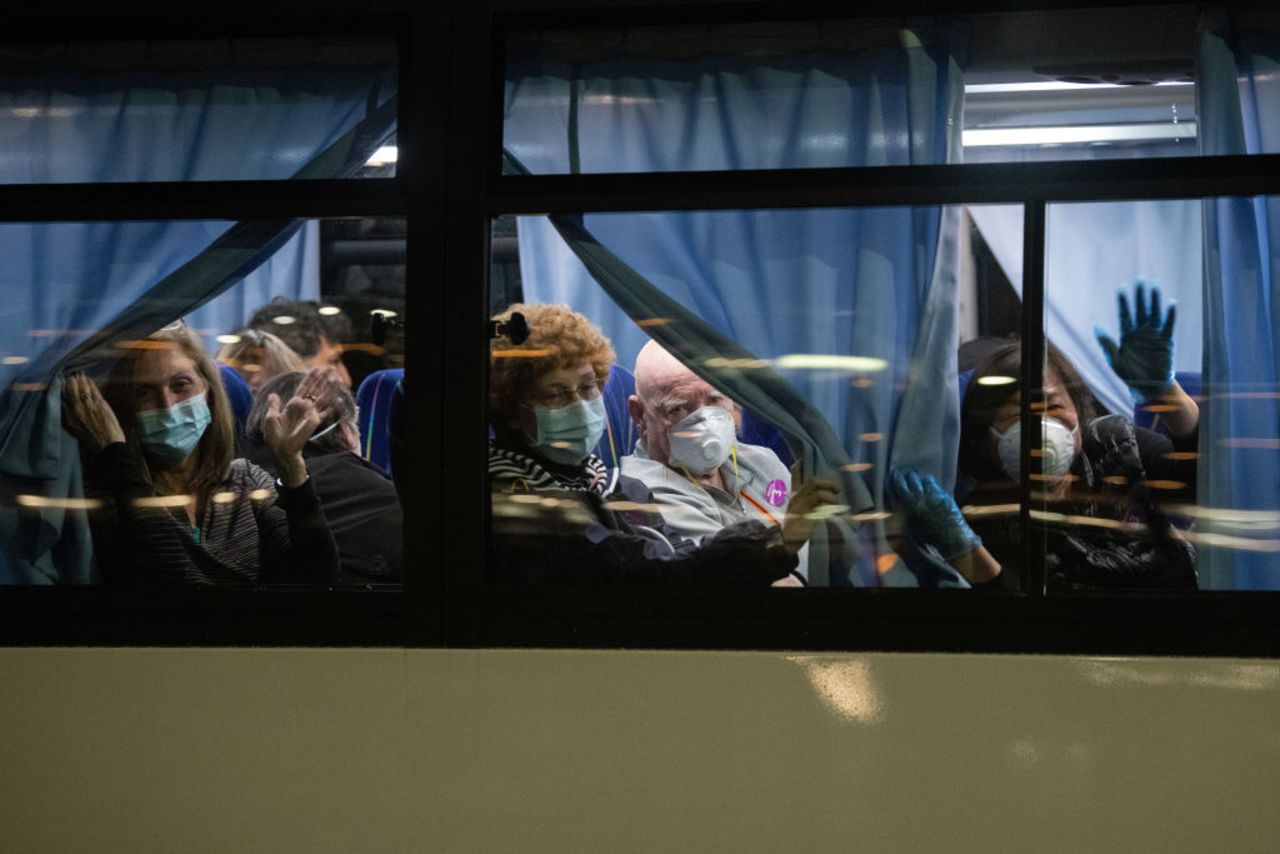 American citizens wave from a bus as they leave the quarantined Diamond Princess cruise ship in Yokohama, Japan on February 17, 2020.