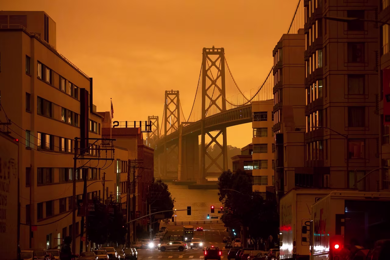 The San Francisco Bay Bridge is seen along Harrison Street under an orange smoke-filled sky in San Francisco on September 9.