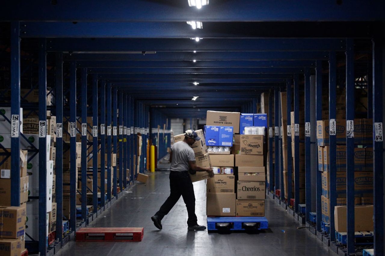 A worker loads boxes onto a pallet at a Kroger Co. grocery distribution center in Louisville, Kentucky, on March 20.