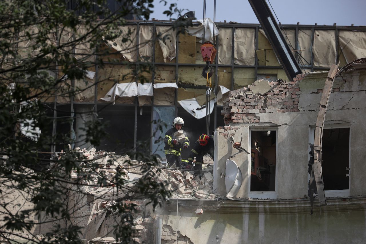 Rescuers work at the site of a residential building hit by a Russian missile strike in?Lviv on Thursday.